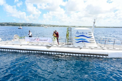 Just Married Couple pose with an Atlantis Submarine Pilot Just Married Couple pose with an Atlantis Submarine Pilot